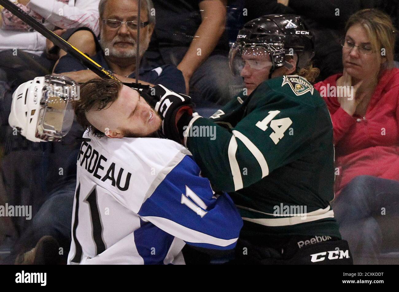 Saint-John Sea Dogs' Jonathan Huberdeau loses his helmet as he is punched  by London Knights' Tommy Hughes (14) during the third period of their  round-robin Memorial Cup ice hockey game in Shawinigan,