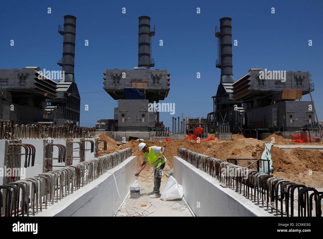 A labourer works at the construction site of Dorad, a private power plant in the southern city of Ashkelon May 17, 2012. Israel Electric Corp (IEC), which is responsible for nearly every aspect of electricity from running power plants to connecting households, simply cannot keep up with growing demand.The state-owned utility just lost natural gas supplies from neighbouring Egypt and fuel costs are soaring. Reserves are low and capacity insufficient and the government, under pressure from massive cost-of-living protests, has limited how much it can charge the public for electricity consumption. Stock Photo