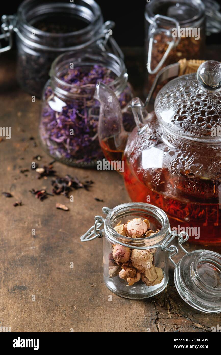 https://c8.alamy.com/comp/2CXKGM9/variety-of-black-green-and-herbal-dry-tea-leaves-in-glass-jars-with-vintage-strainer-and-teapot-of-hot-tea-over-old-dark-wooden-background-close-up-2CXKGM9.jpg