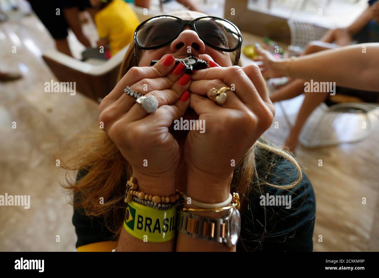 Paula Santana celebrates the victory by Brazil after the round of 16 soccer match against Chile for the 2014 World Cup, during a gathering at a home in the upper class neighborhood of Lago Sul in Brasilia, June 28, 2014.  REUTERS/Ueslei Marcelino (BRAZIL  - Tags:  SOCCER SPORT WORLD CUP) Stock Photo
