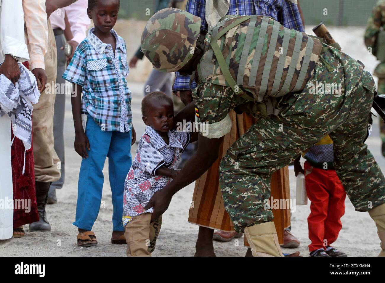 A Soldier Serving In The African Union Mission In Somalia Amisom Frisks A Muslim Child Before