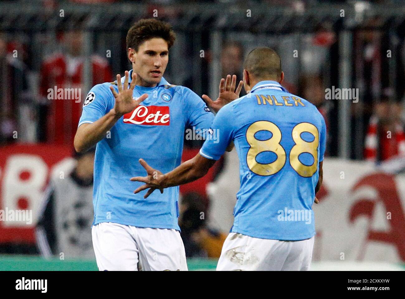 Napoli's Federico Fernandez (L) and Goekhan Inler celebrate during their  Champions League Group A soccer match against Bayern Munich in Munich  November 2, 2011. REUTERS/Michael Dalder (GERMANY - Tags: SPORT SOCCER Stock