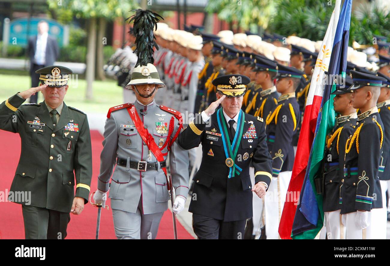 Phillipine Armed Forces Chief of Staff Lieutenant General Jessie Dellosa (L) and his counterpart Chairman of the Joint Chiefs of Staff U.S. Army General Martin Dempsey (R) salute an honour guard during a welcoming ceremony at the Philippine Armed Forces military headquarters in Quezon city, Metro Manila June 4, 2012. Dempsey met separately with President Benigno Aquino III and Lieutenant General Dellosa, to discuss, among other topics, the tensions over the West Philippine Sea and standoff over the Scarborough Shoal with China, local media reported.   REUTERS/Erik De Castro (PHILIPPINES - Tags Stock Photo