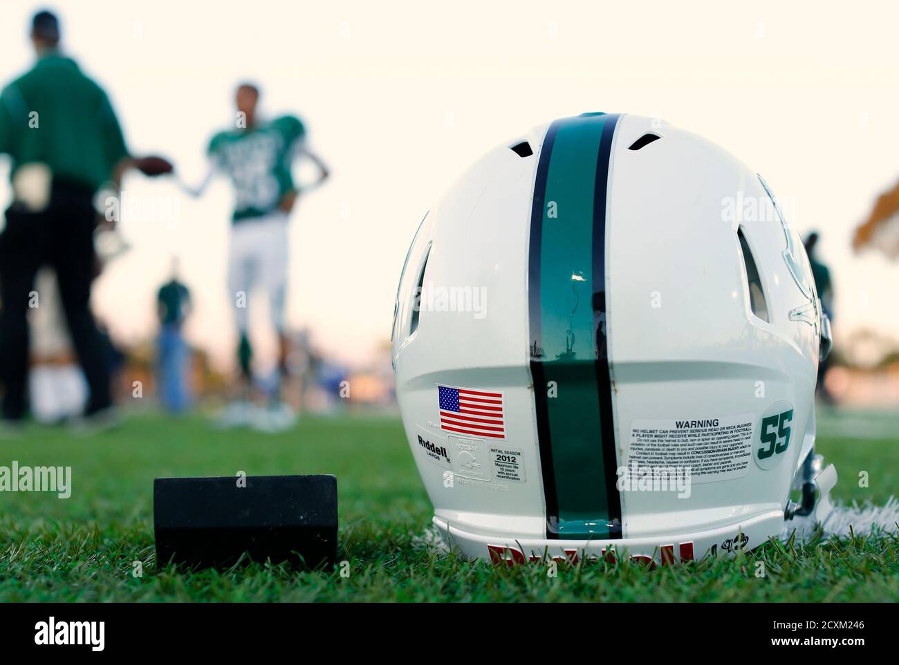 A football helmet's health warning sticker is pictured ...