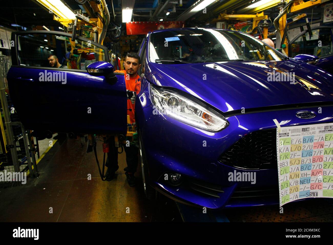 A Worker Mounts A Door To A Fiesta St At The Fiesta Assembly Line Of Ford Germany In Cologne February 4 13 Europe S Car Sales Fell Last Month To Their Lowest February