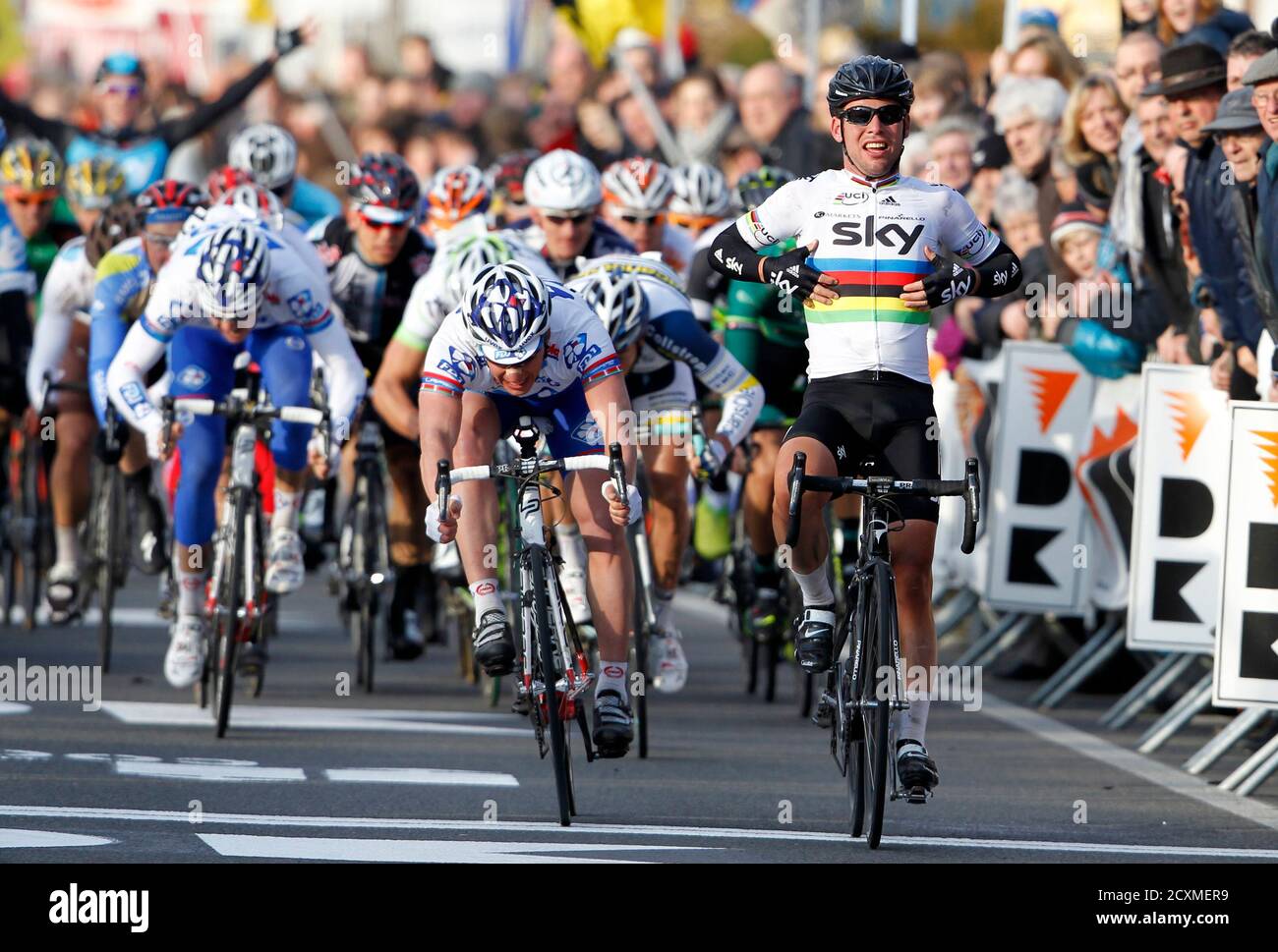 Team Sky rider Mark Cavendish (R) of Britain celebrates as he wins the Kuurne-Brussels-Kuurne cycling race in Kuurne February 26, 2012. Cavendish the race ahead of FDJ rider Yauheni Hutarovich (