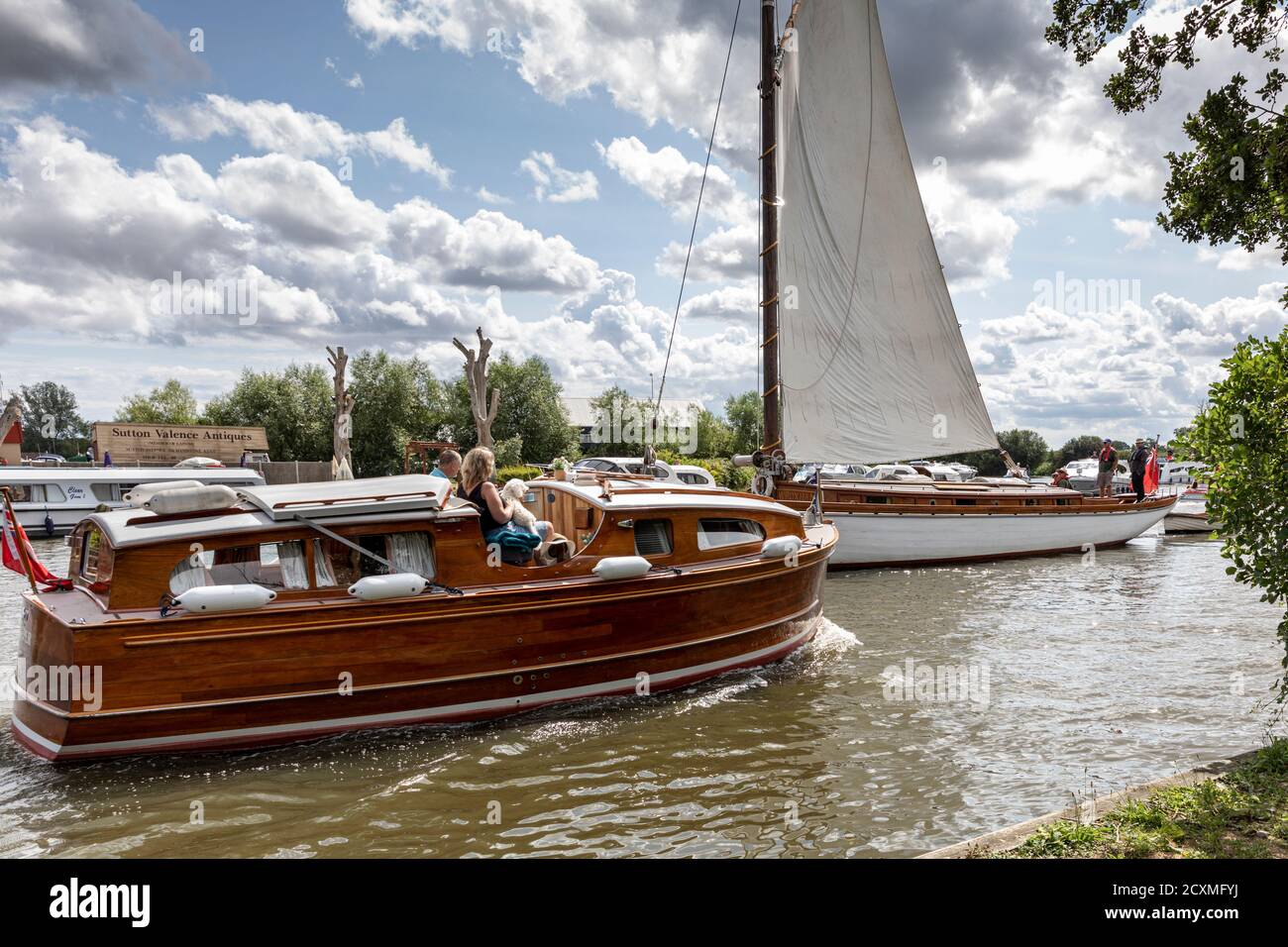 Numerous kinds of vessels making their way on the busy river Bure at Horning, Norfolk Broads, England Stock Photo