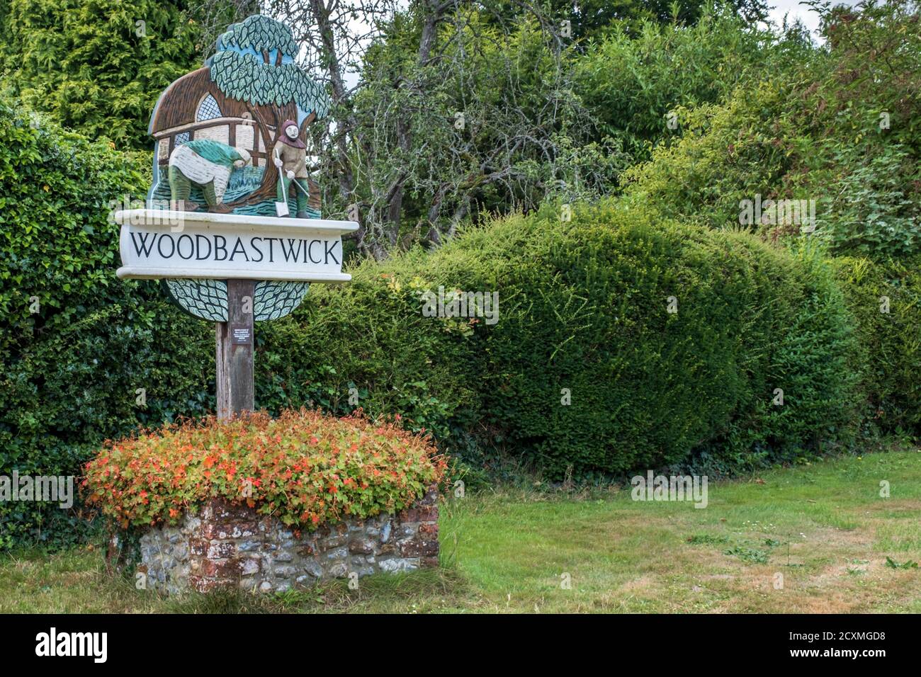 Woodbastwick village sign, showing two Danish and Saxon invaders tying their leggings. Norfolk Broads, England. Stock Photo