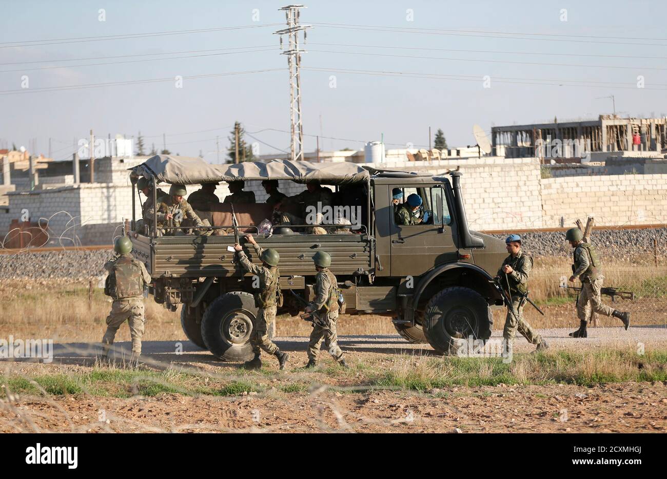 Turkish soldiers, with the northern Syrian town of Ras al-Ain in the  background, change guards on the Turkish-Syrian border in Ceylanpinar,  southern Sanliurfa province, November 10, 2012. Thousands of Syrians fled  their