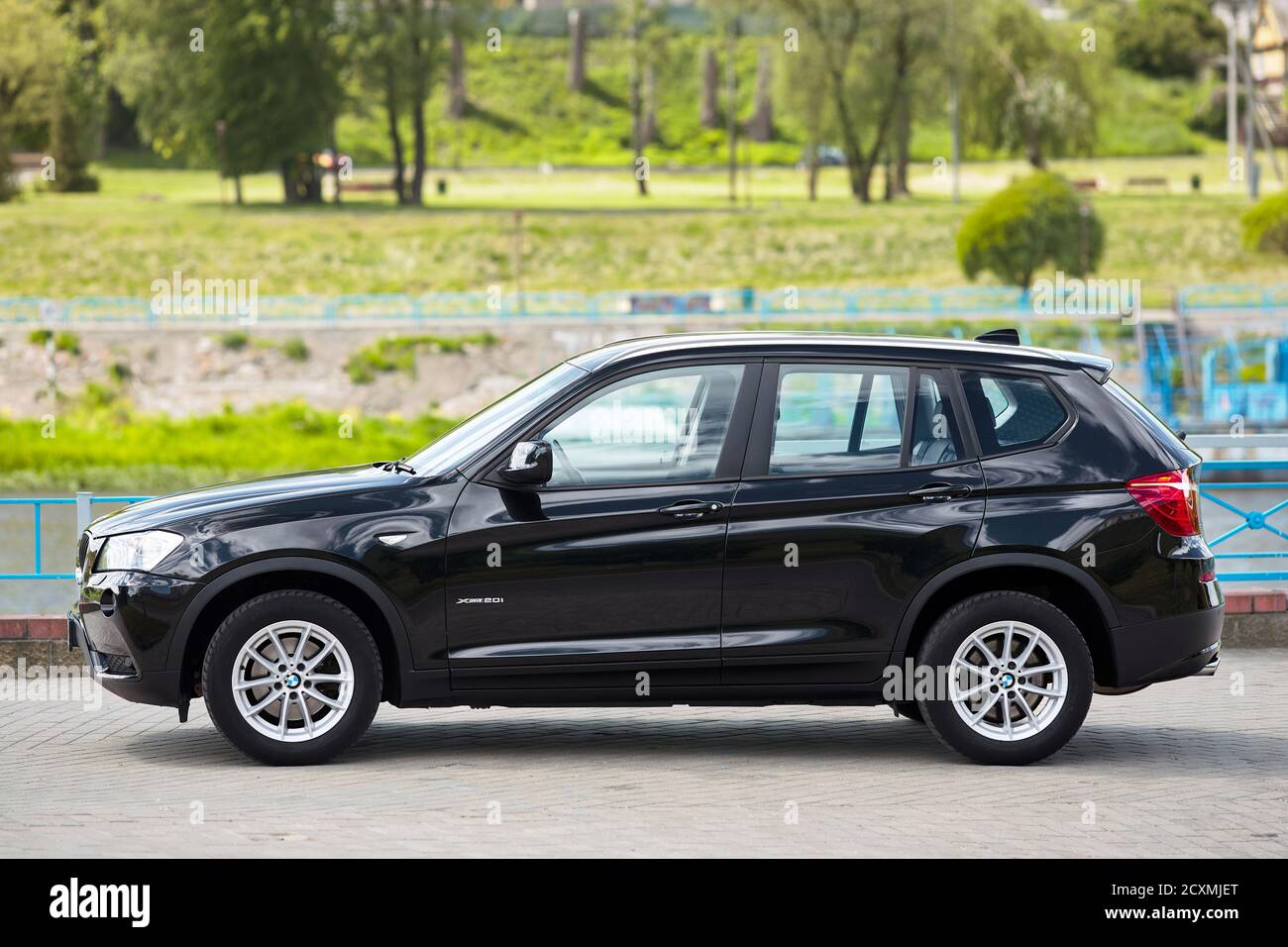 GRODNO, BELARUS - JUNE 2020: BMW X3 II F25 2.0i xDrive selective focus left side view outdoors on sunny road background of summer city promenade Stock Photo