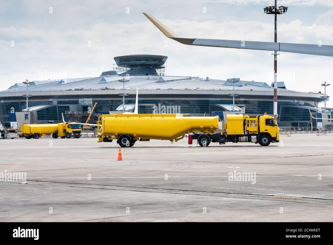 Two yellow tank truck aircraft refuelers at the airport apron Stock ...
