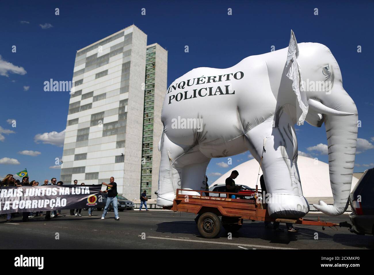 Federal police walk with an inflatable elephant to represent what they say is slowness in police investigation procedures during the 'March for Reform of the Federal Police' in front of the National Congress in Brasilia July 16, 2013. The protesters demanded changes in the structure and modernization of criminal investigations. REUTERS/Ueslei Marcelino (BRAZIL - Tags: BUSINESS EMPLOYMENT CRIME LAW CIVIL UNREST) Stock Photo