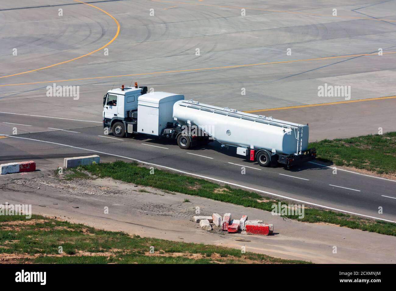Tank truck aircraft refueler moves on the airport apron Stock Photo - Alamy