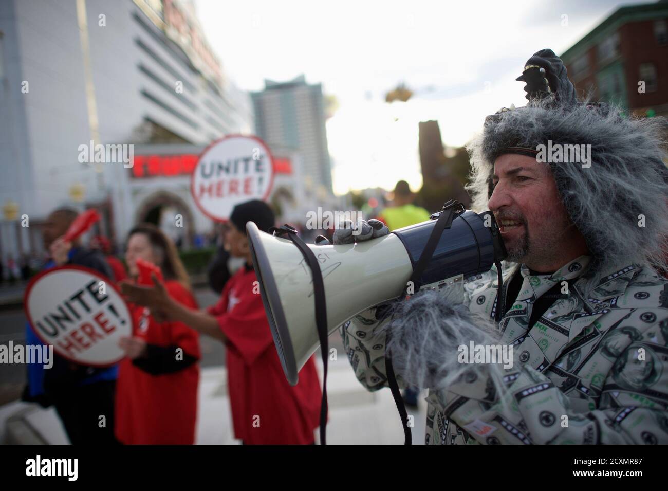 Paul Smith, dressed in a costume referring to the "Wolf of Wall Street,"  chants on a megaphone during a rally by union members from UNITE HERE Local  54 outside the Trump Taj