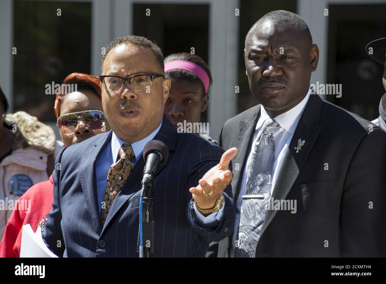 Michael Brown's family lawyers Anthony Gray (C) and Benjamin Crump (R), stand with his mother Lesley McSpadden (L) as they announce the Brown family has filed a wrongful death lawsuit against the city of Ferguson in front of the St. Louis County Circuit Court in Clayton, Missouri, April 23, 2015. The family of Michael Brown filed a wrongful death lawsuit against the city of Ferguson on Thursday, seeking unspecified damages and police reforms after the black teen's killing by a white policeman prompted a national debate on law enforcement and race. REUTERS/Kate Munsch Stock Photo