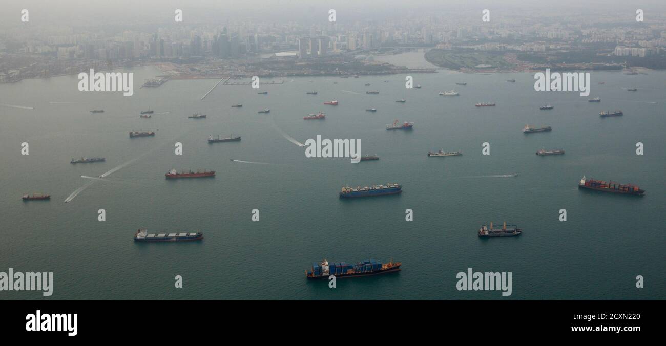 Commercial ships line up at the Strait of Singapore February 14, 2012. REUTERS/Edgar Su (SINGAPORE - Tags: TRANSPORT BUSINESS) Stock Photo