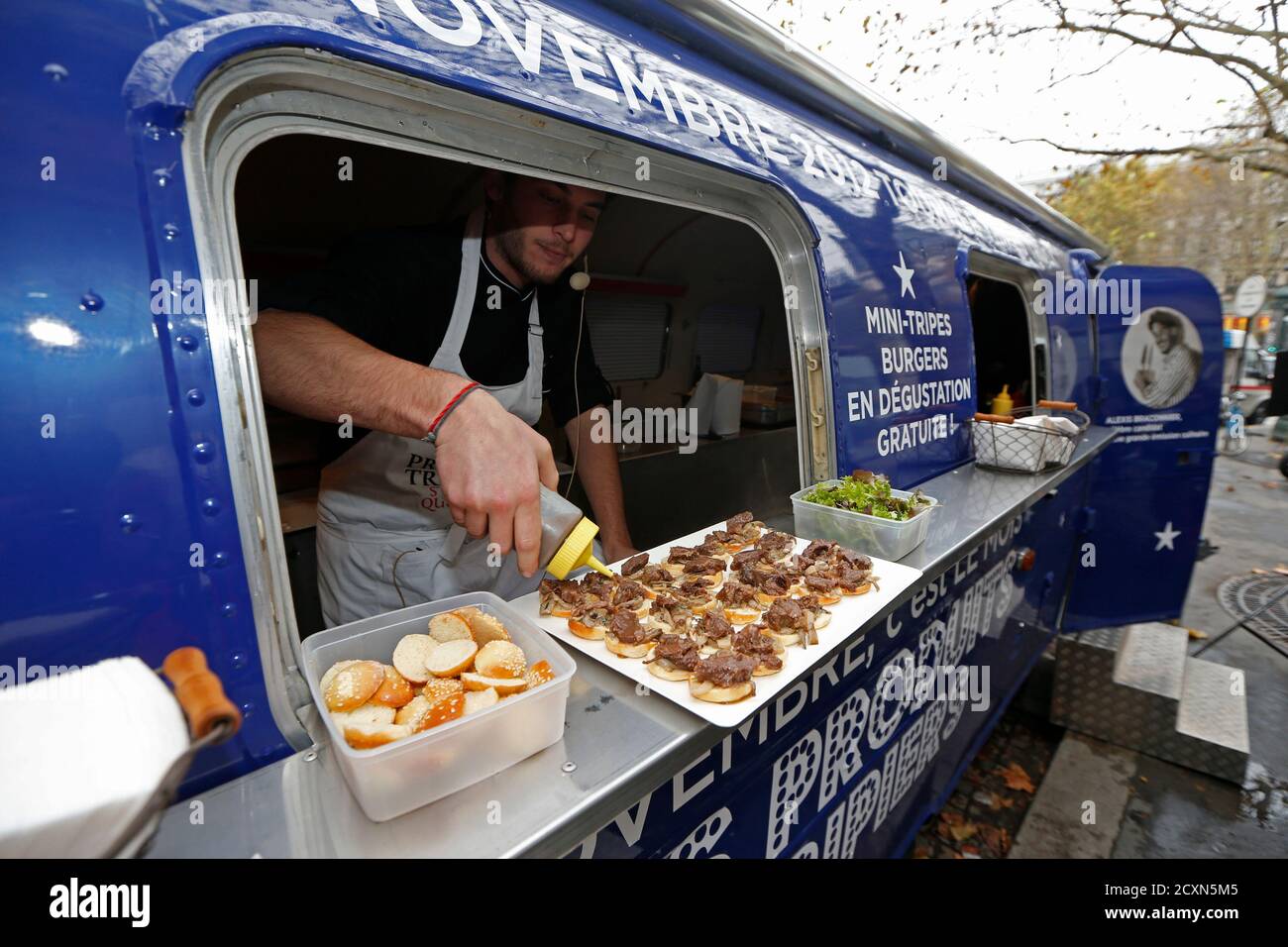 Chef Alexis Braconnier prepares small tripes burger in a food truck in  Paris October 13, 2012. Chef Alexis Braconnier has cooked during one week  to promote tripes products. This is part of