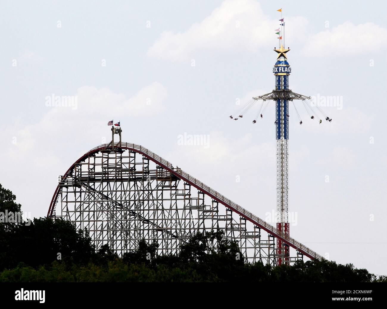 The Texas Giant roller coaster ride (L) is seen at the Six Flags Over Texas amusement park in Arlington, Texas July 23, 2013.  A woman who plunged from the Texas Giant roller coaster ride at the Six Flags Over Texas amusement park died of multiple traumatic injuries in a fall that was ruled an accident, authorities said on Monday.  REUTERS/Mike Stone (UNITED STATES - Tags: SOCIETY) Stock Photo