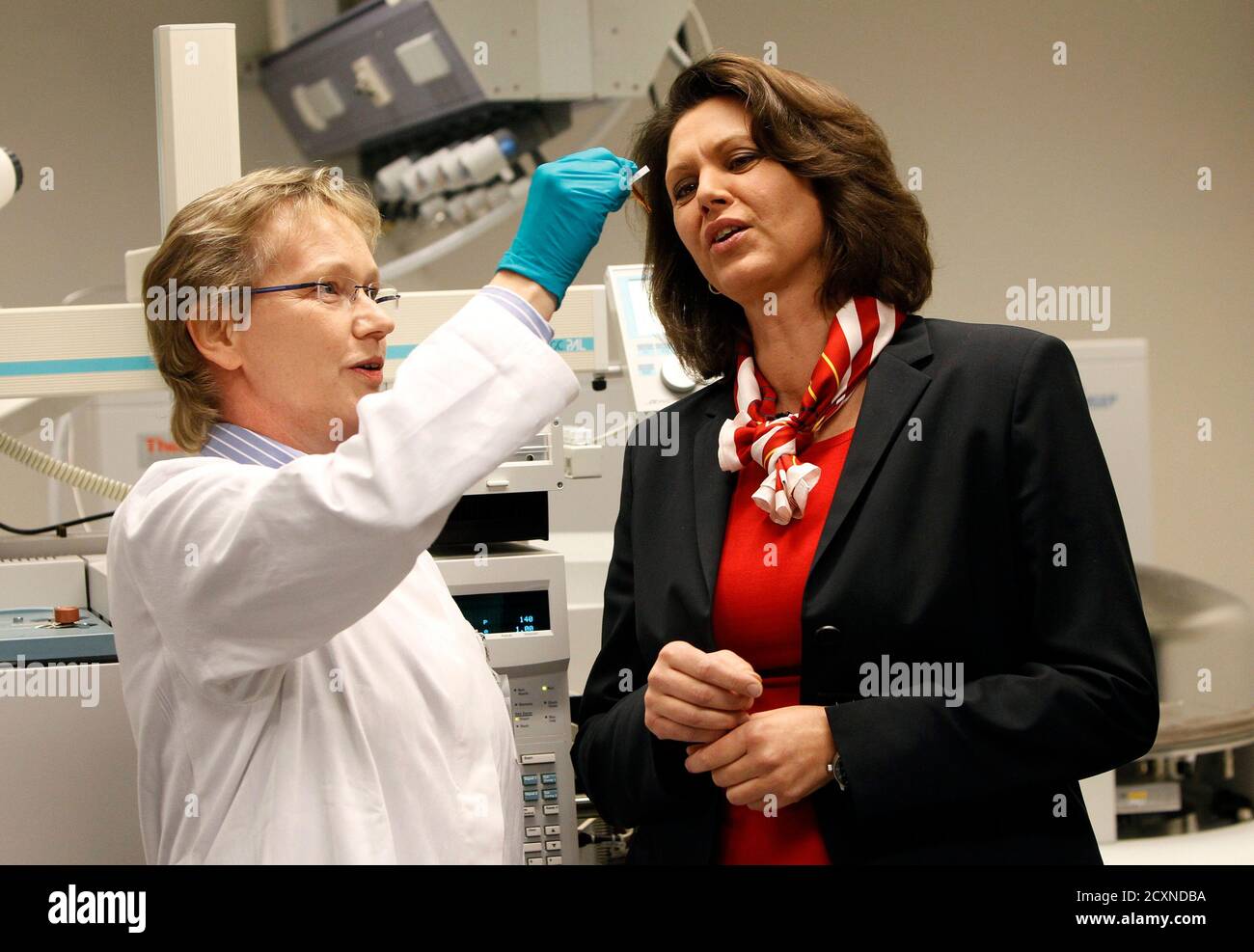 German Agriculture Minister Ilse Aigner watches a Dioxin test sample  displayed by Elke Bruns-Weller (L), head of the Dioxin test laboratory,  during her visit at a laboratory of Lower Saxony's State Office