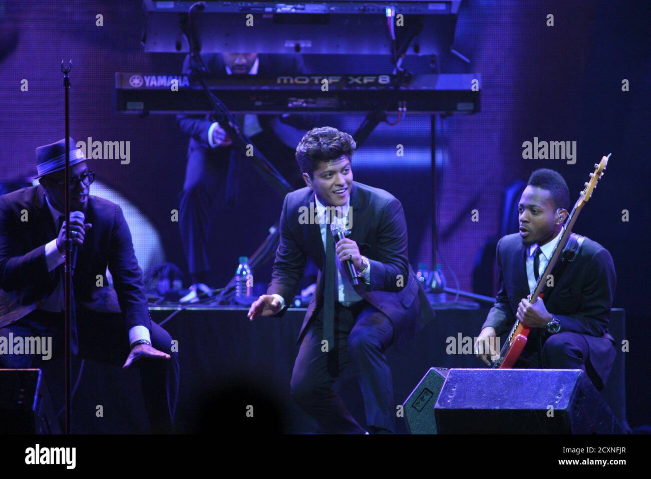 Bruno Mars (C) performs with members of his band during the first day of  the iHeartRadio Music Festival at the MGM Grand Garden Arena in Las Vegas,  Nevada September 23, 2011. The