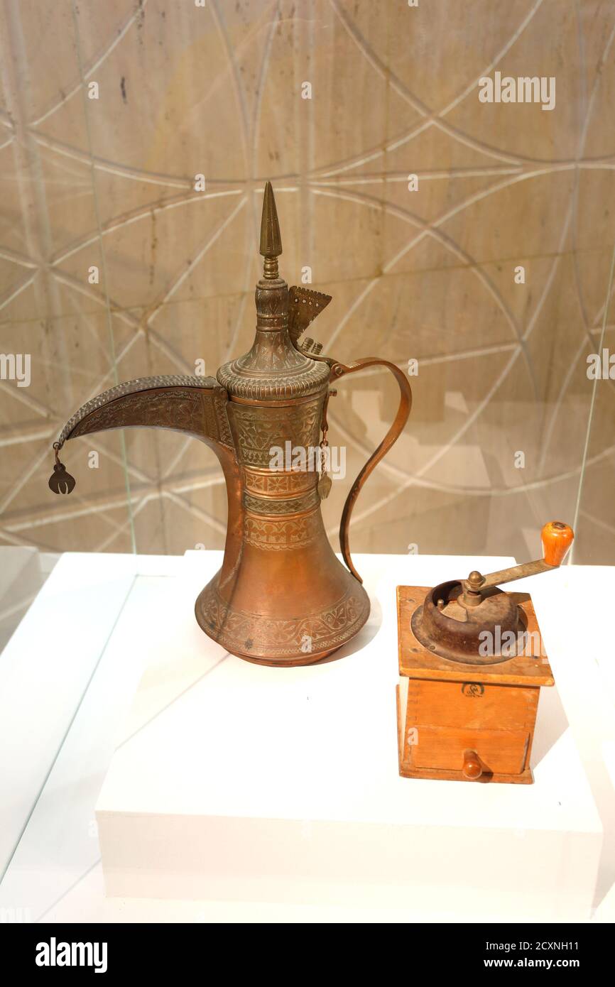 Traditional Arab coffee pot, dallah, and coffee grinder, on display at the National Museum, Manama, Kingdom of Bahrain Stock Photo