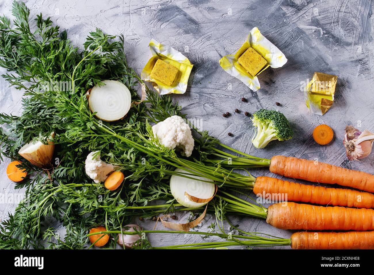 Raw Vegetables And Bouillon Cubes For Cooking Soup. Young Carrot With 