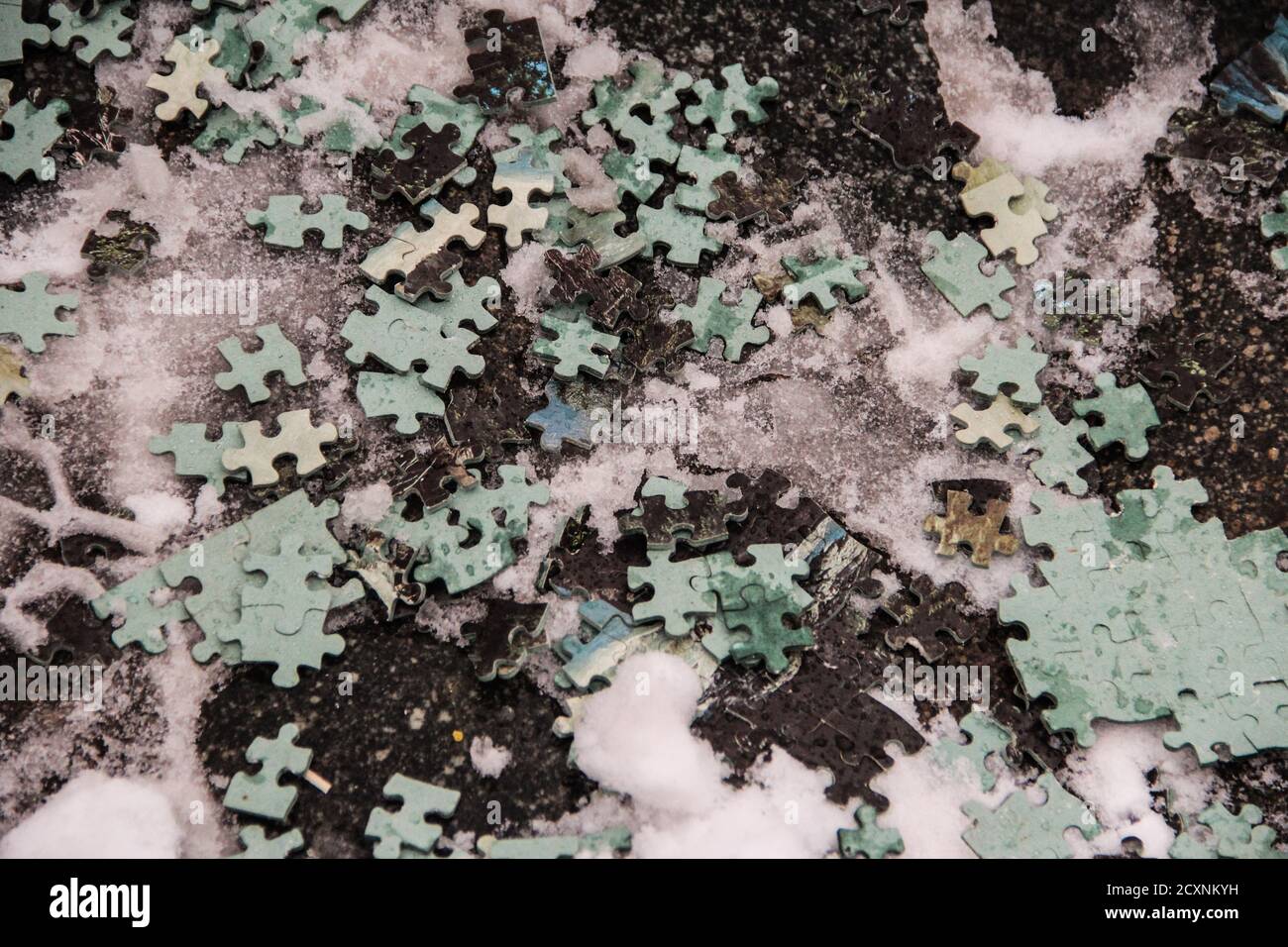 black and green puzzle spread in a snow landscape during wintertimes Stock Photo