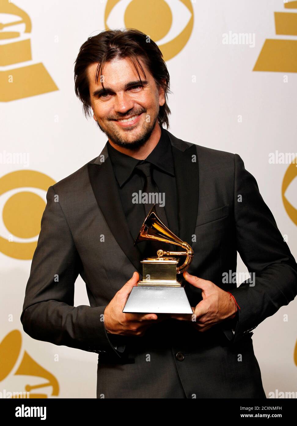Juanes holds the award he won for Best Latin Pop Album for "MTV Unplugged  Deluxe Edition" backstage at the 55th annual Grammy Awards in Los Angeles,  California February 10, 2013. REUTERS/Mario Anzuoni (