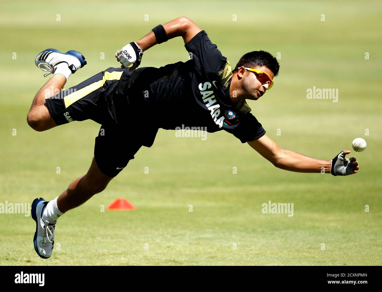 India's cricket player Suresh Raina takes part in a training session ahead of their first One-Day International (ODI)  against South Africa on Thursday, in Johannesburg December 4, 2013. REUTERS/Siphiwe Sibeko (SOUTH AFRICA - Tags: SPORT CRICKET) Stock Photo