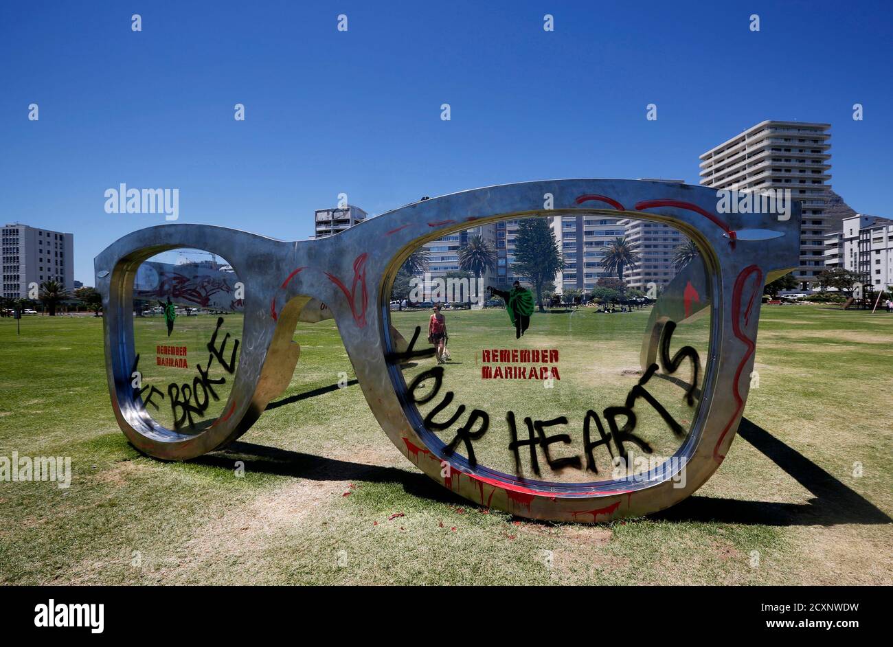 Graffiti covers a sculpture in the form of a giant pair of spectacles on Cape Town's Sea Point Promenade, November 18, 2014.  Inspired by Nelson Mandela, the work  'Perceiving Freedom' by artist Michael Elion has stirred some controversy in the local media. While popular with visitors to the promenade, some critics have questioned the association of Mandela's legacy with commercial sponsors.  REUTERS/Mike Hutchings (SOUTH AFRICA - Tags: SOCIETY) Stock Photo