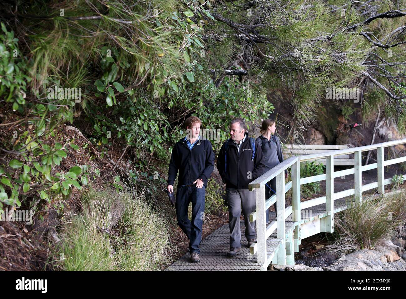 Britain's Prince Harry (L) walks with Brent Beaven (C) and Kate Richardson of the New Zealand Department of Conservation, at Sydney Cove during their visit to Ulva Island off the coast off New Zealand's south island May 10, 2015.   REUTERS/Dianne Manson/Pool Stock Photo