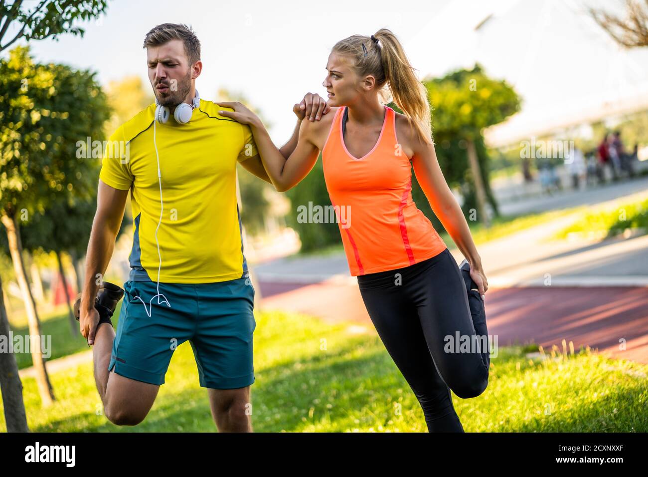 Smiling Young Couple Training Outside Together · Free Stock Photo