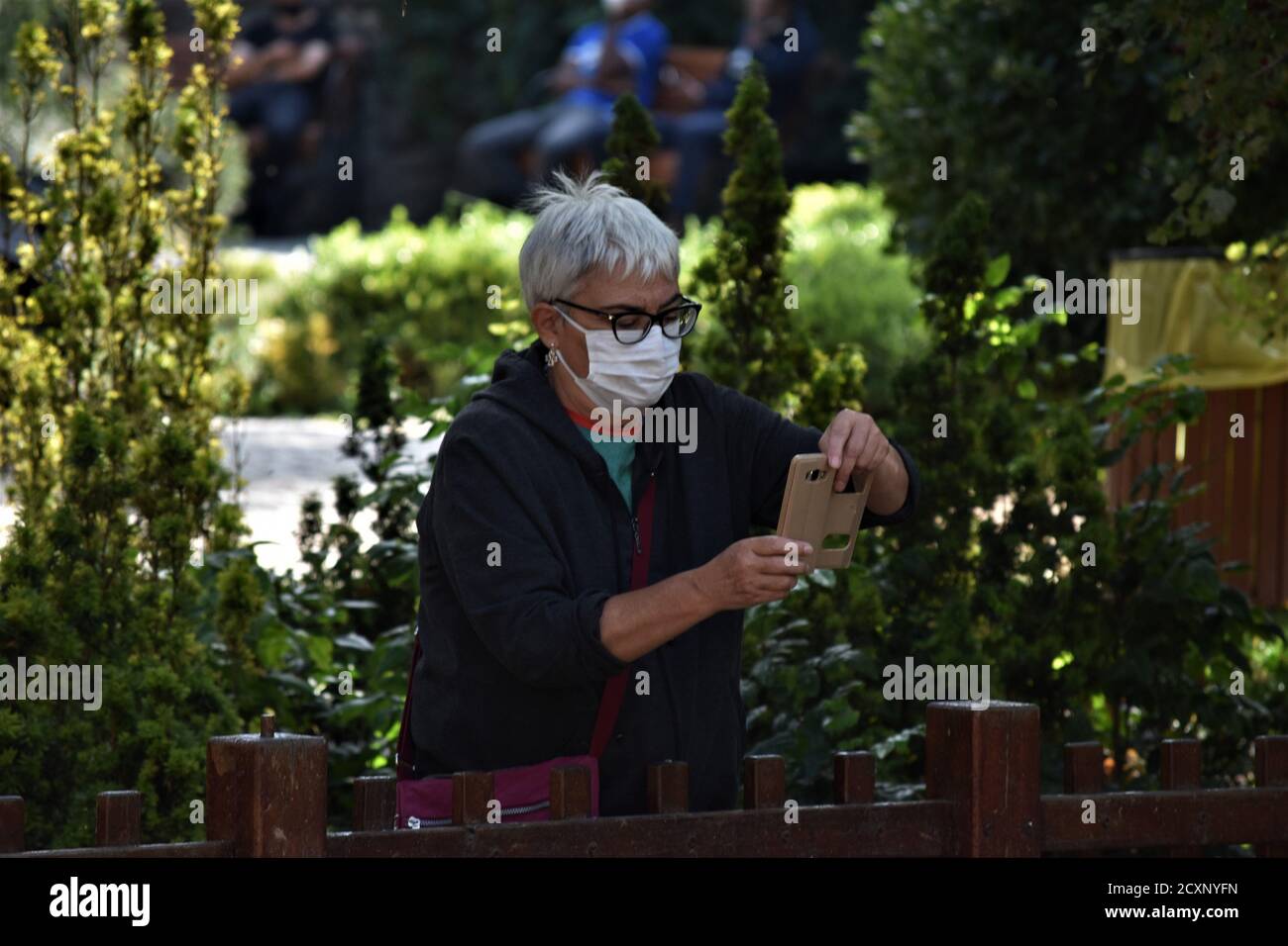 Ankara, Turkey. 1st Oct, 2020. A woman wearing a protective face mask takes photographs in Kugulu Park amid the coronavirus (COVID-19) outbreak. Turkish Minister of Health Fahrettin Koca admitted on September 30 that asymptomatic cases of the coronavirus are deliberately excluded from daily reports. The minister's statement came after the revelation of a document showing nearly 20 times more cases than the official daily figures. Credit: Altan Gocher/ZUMA Wire/Alamy Live News Stock Photo