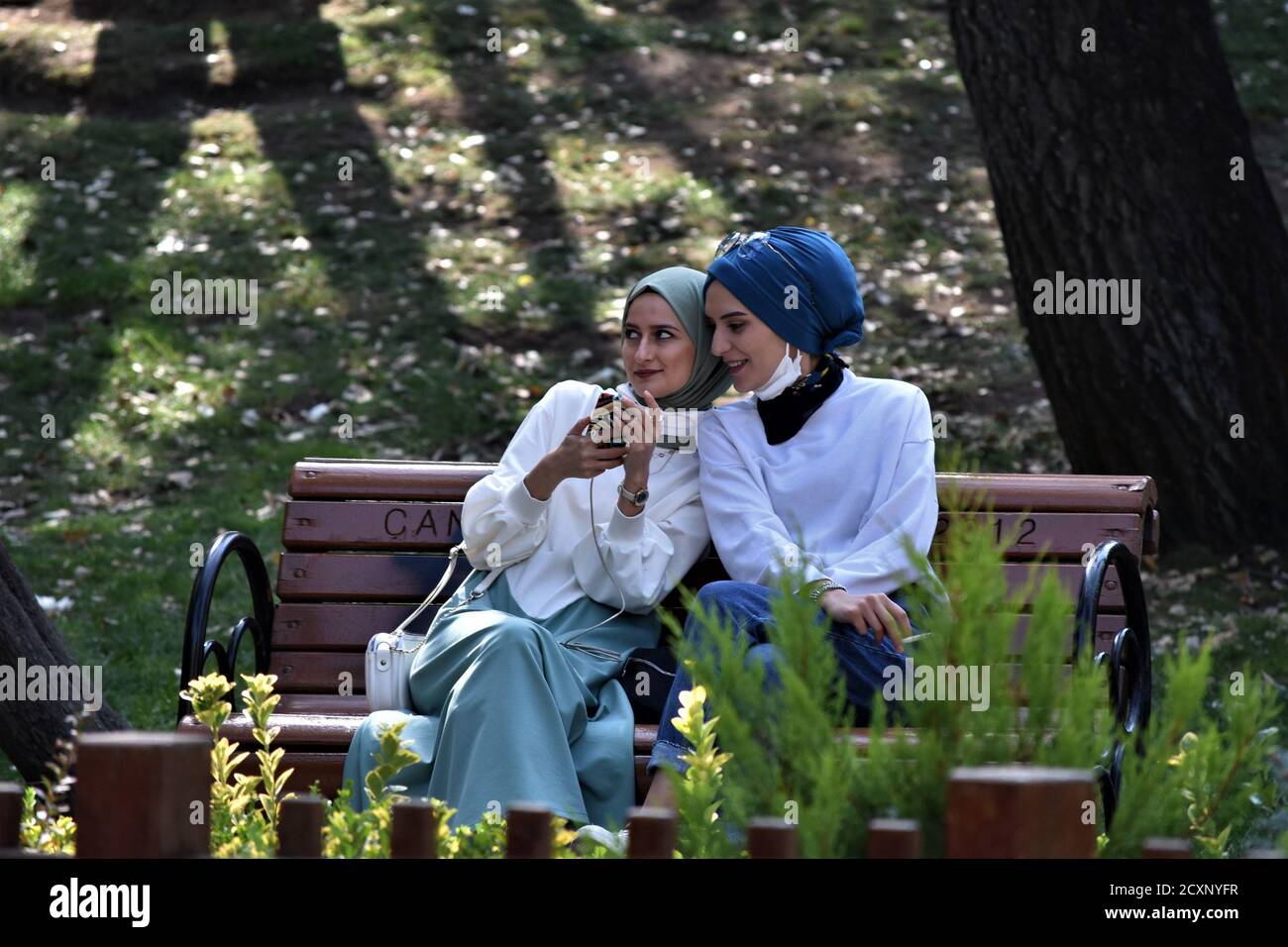 Ankara, Turkey. 1st Oct, 2020. Two young women enjoy a nice weather in Kugulu Park amid the coronavirus (COVID-19) outbreak. Turkish Minister of Health Fahrettin Koca admitted on September 30 that asymptomatic cases of the coronavirus are deliberately excluded from daily reports. The minister's statement came after the revelation of a document showing nearly 20 times more cases than the official daily figures. Credit: Altan Gocher/ZUMA Wire/Alamy Live News Stock Photo