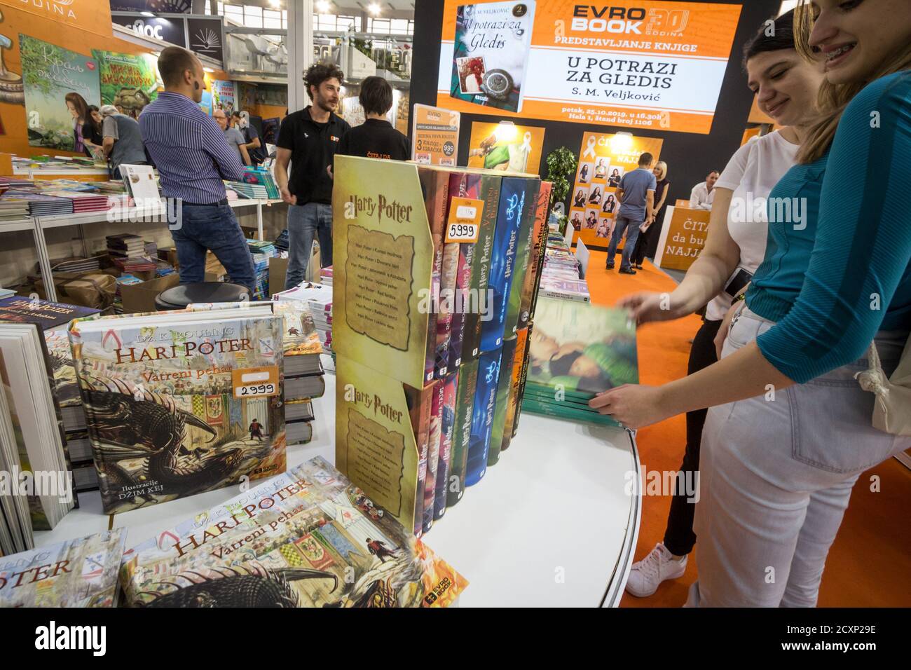 BELGRADE, SERBIA - OCTOBER 10, 2019: Girls reading and looking at covers of harry Potter books in a bookstore. Written by JK Rowling, Harry Potter is Stock Photo