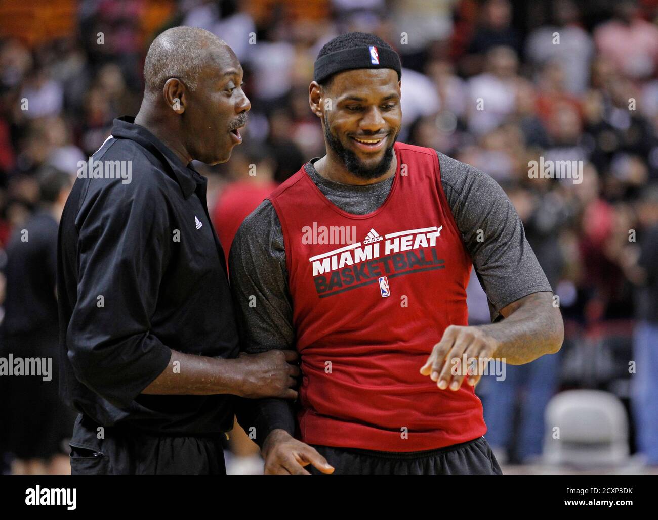 LeBron James of Miami Heat shares a laugh with Heat assistant coach and  former NBA player Bob McAdoo (L) during team practice in front of season  ticket holders before the start of