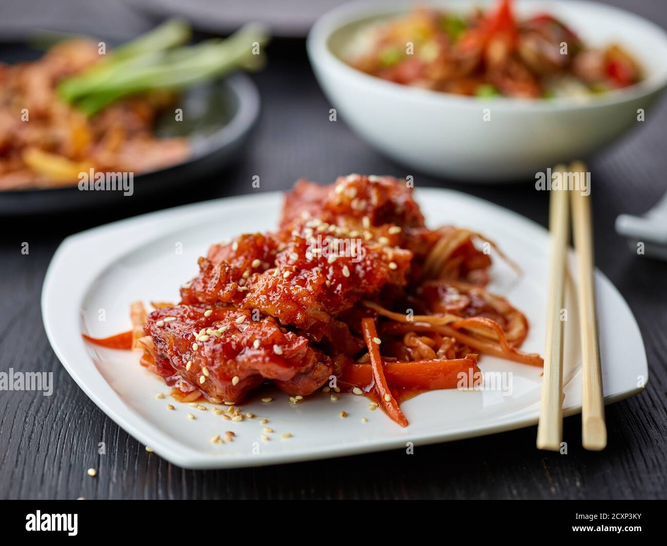 plate of fried meat in teriyaki sauce portion on restaurant table Stock Photo