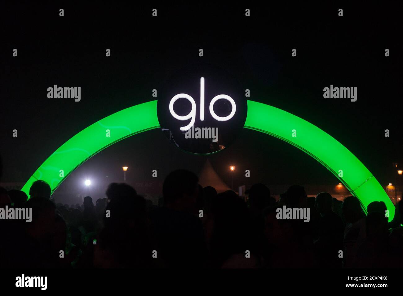 BELGRADE, SERBIA - AUGUST 17, 2019: Glo logo in front of a local retailer at night in Serbia. Glo, beloning to British American Tobacco is a tobacco h Stock Photo