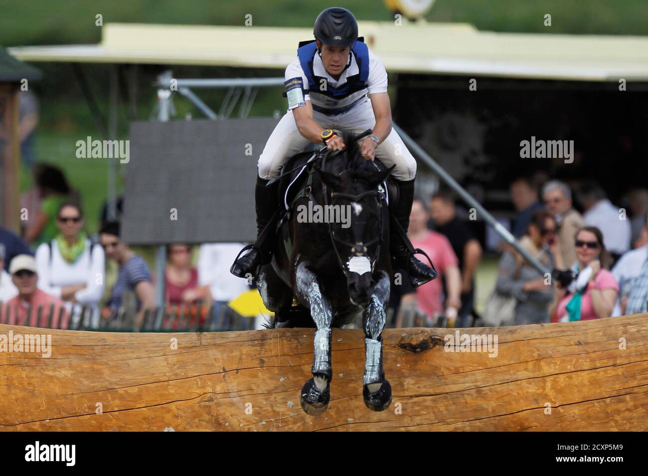Christopher Burton of Australia clears a jump on his horse,  Underdiscussion, during the Cross Country Test of the World Equestrian  Festival CHIO in Aachen July 7, 2012. REUTERS/Alex Domanski (GERMANY - Tags:
