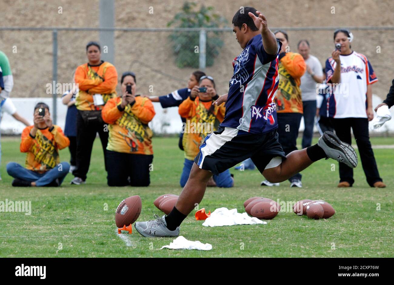Fifteen-year-old Chelsen Victorino of Kaunakakai, Hawaii kicks the ball in the Punt, Pass & Kickk competition in front of family prior to the Cincinnati Bengals playing against the San Diego Chargers in their NFL football game in San Diego, California December 2, 2012.  Punt, Pass & Kick competition in five age gendered groups with the top scorer in each group crowned team champion, the top four scorers from all the teams compete for the National Championships to be held during an NFC playoff game.   REUTERS/Alex Gallardo (UNITED STATES - Tags: SPORT FOOTBALL) Stock Photo