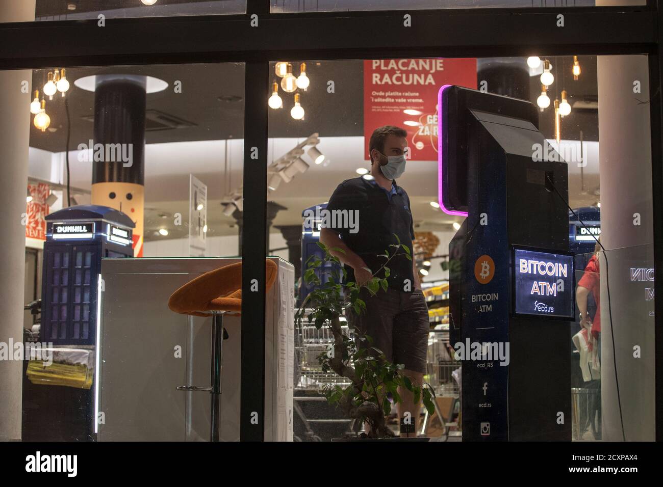 BELGRADE, SERBIA - SEPTEMBER 17, 2020: Man buying bitcoins from a  cryptocurrency ATM wearing a respiratory face mask in Belgrade, during the  coronavir Stock Photo - Alamy