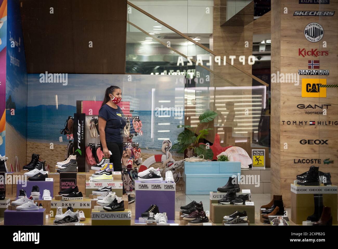 BELGRADE, SERBIA - SEPTEMBER 4, 2020: Employee of a shoe store footwear  boutique standing alone around shoes wearing a respiratory face mask in  Belgr Stock Photo - Alamy