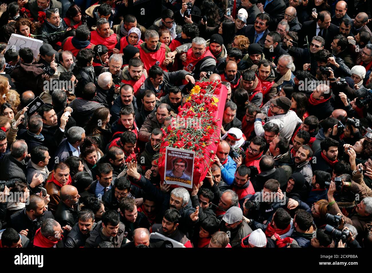 Mourners carry the coffin of Berkin Elvan during funeral ceremony in Okmeydani cemevi, an Alevi place of worship, in Istanbul March 12, 2014. Several thousand mourners gathered in central Istanbul on Wednesday for the funeral of Elvan, a 15-year-old boy wounded during anti-government demonstrations last summer whose death on Tuesday triggered protests across Turkey. REUTERS/Murad Sezer (TURKEY  - Tags: POLITICS CIVIL UNREST TPX IMAGES OF THE DAY) Stock Photo