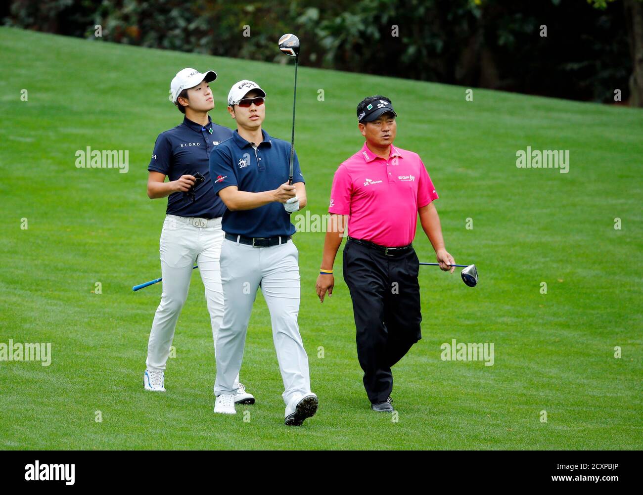 South Korean golfers Chang-woo Lee,(L), Sang Moon Bae, and K.J. Choi (R)  walk up the 11th fairway during a practice round ahead of the Masters golf  tournament at the Augusta National Golf