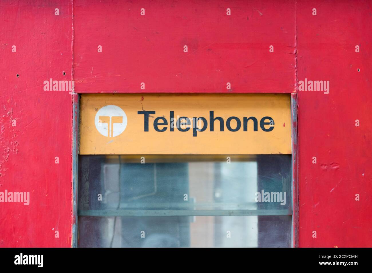 A close up of an old Telecom Australia (pre Telstra) wooden and glass red  phone booth in an auction house in Sydney Stock Photo - Alamy