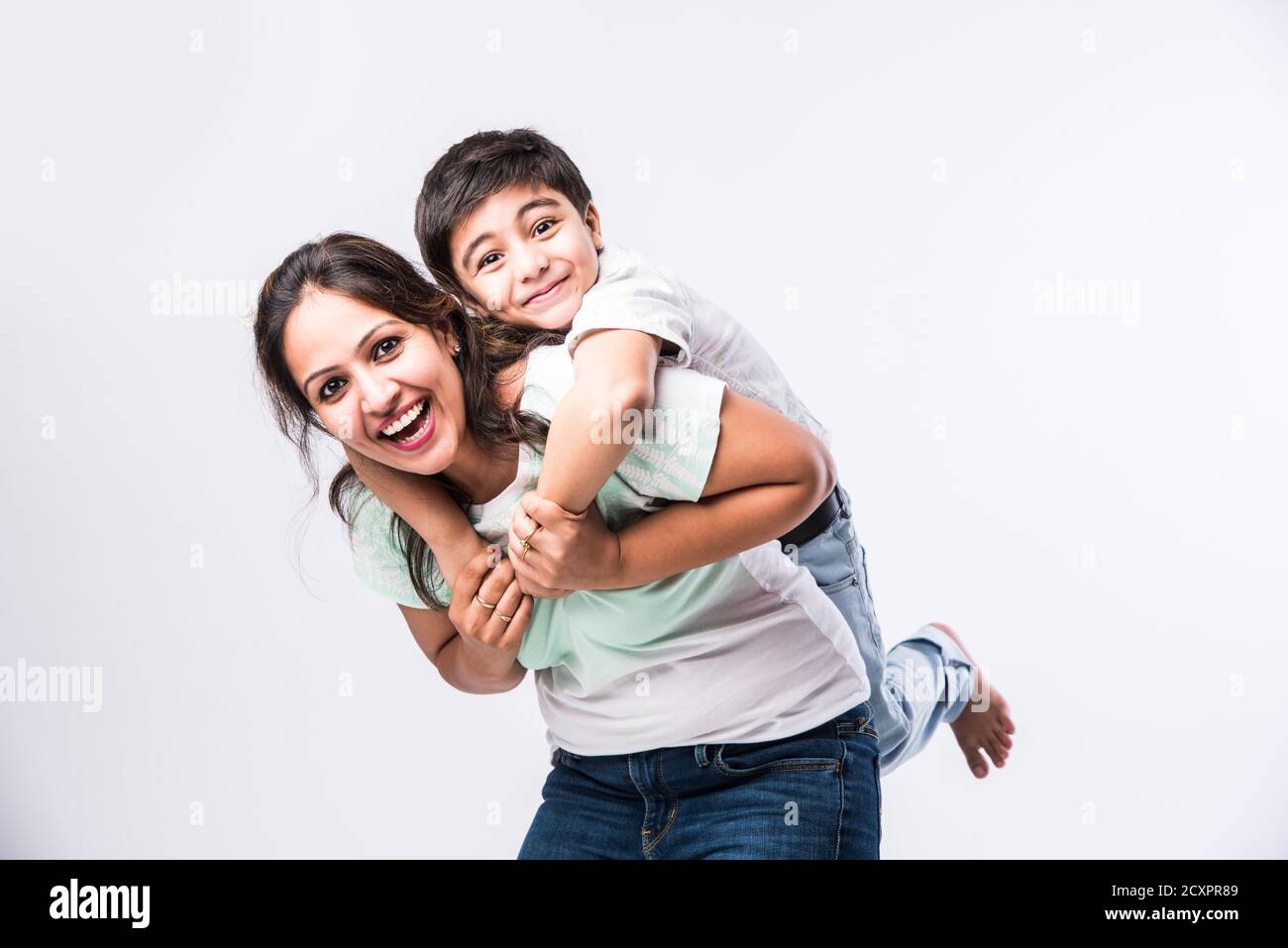 Portrait of Indian young mother and son against white background