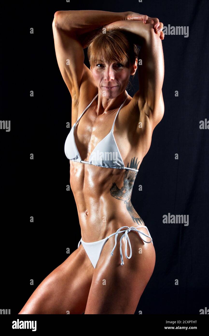 Forty year old woman showing off her muscles Stock Photo