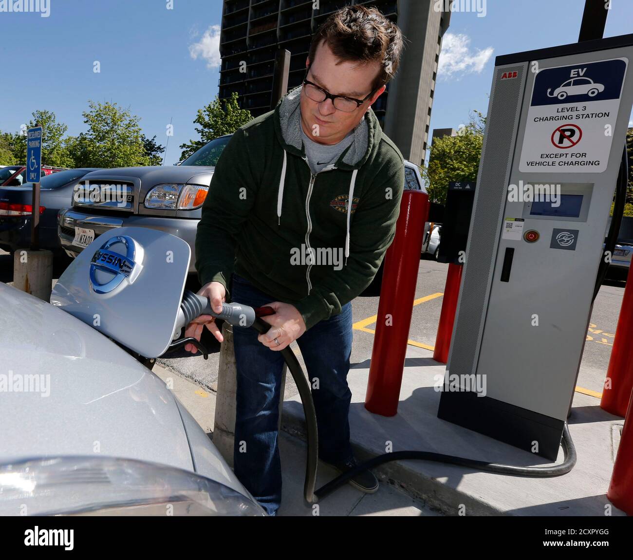 Justin Miller Hooks Up A Charging Cable So He Can Charge His 2013 Nissan Leaf Electric Car At Abb Inc S Dc Fast Charging Station In Salt Lake City Utah April 30 2014