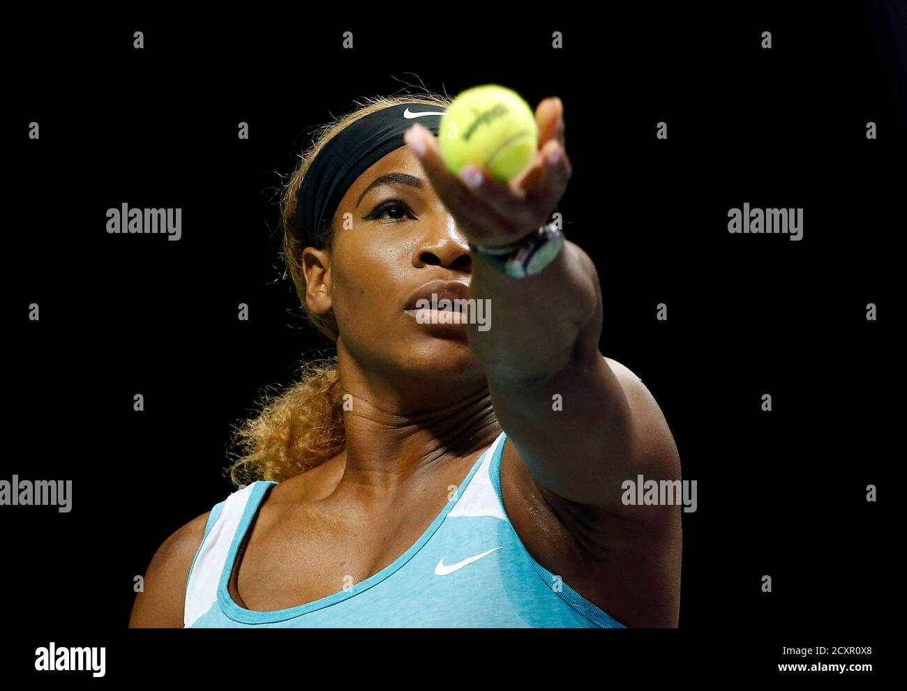 Serena Williams of the U.S. serves to Simona Halep of Romania during their  women's singles final tennis match of the WTA Finals at the Singapore  Indoor Stadium October 26, 2014. REUTERS/Edgar Su (