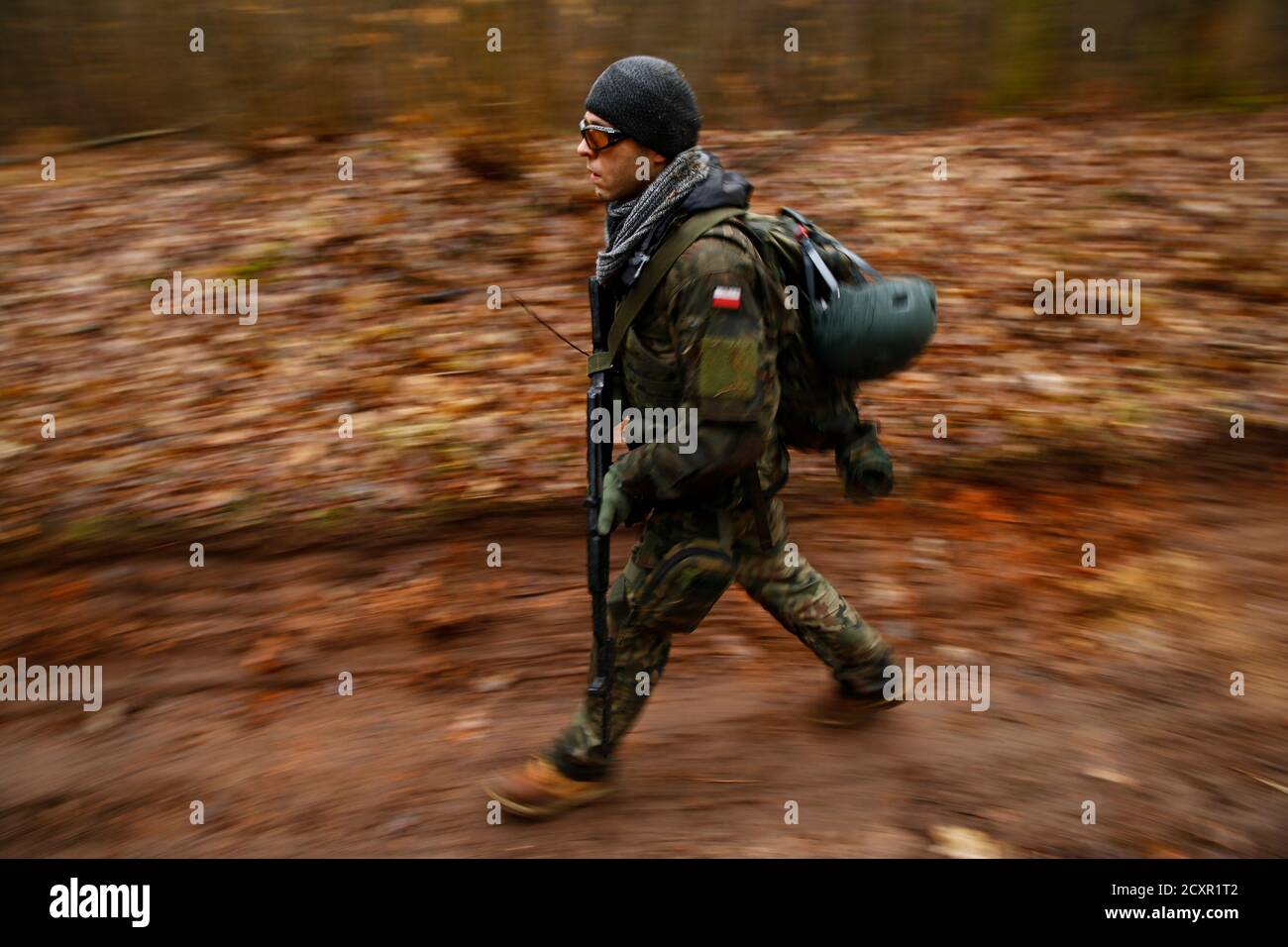 A man takes part in an endurance march during a territorial defence  training organised by paramilitary group SJS Strzelec (Shooters  Association) in the forest near Minsk Mazowiecki, eastern Poland March 14,  2014.